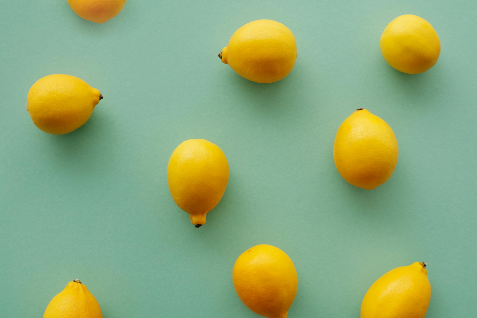 Bright yellow lemons on a pastel background, representing the Lemon Clitoral Vibrator